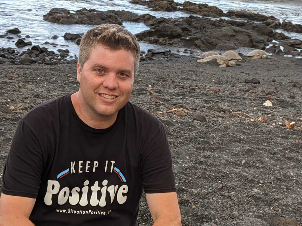 Matt Cavallo at the Black Sand Beach on the Big Island of Hawaii with Green Sea Turtles nesting by the ocean.
